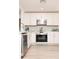 Well-equipped kitchen with stainless steel appliances and white cabinets, designed for efficiency at 4586 12Th N Ave, St Petersburg, FL 33713
