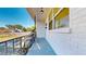 View of the covered front porch with white brick and black railings at 4586 12Th N Ave, St Petersburg, FL 33713