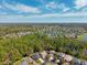 Beautiful aerial view of the neighborhood, showcasing lush green trees, community lakes and many single-Gathering homes at 4821 Barchetta Dr, Land O Lakes, FL 34639