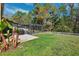 Relaxing backyard oasis with a screened pool enclosure, patio area, and well-maintained lawn at 4821 Barchetta Dr, Land O Lakes, FL 34639