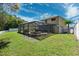 Spacious backyard features a screened pool, lush green grass, shed and a privacy fence at 4821 Barchetta Dr, Land O Lakes, FL 34639