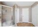 This bathroom has a glass shower, tile floors and multiple linen closets at 4821 Barchetta Dr, Land O Lakes, FL 34639