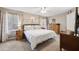 A comfy bedroom features bright windows and natural-colored walls and carpet at 4821 Barchetta Dr, Land O Lakes, FL 34639