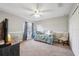 Comfortable bedroom with a daybed, ceiling fan, and carpet flooring, creating a cozy and inviting space at 4821 Barchetta Dr, Land O Lakes, FL 34639
