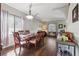 Dining area with hardwood floors, hutch, elegant light fixture, and bar cart with wine glass storage at 4821 Barchetta Dr, Land O Lakes, FL 34639