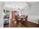Dining area with hardwood floors, hutch, elegant light fixture, and bar cart with wine glass storage at 4821 Barchetta Dr, Land O Lakes, FL 34639