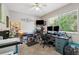 Functional home office with two desks, a large window, and carpet flooring, creating a productive workspace at 4821 Barchetta Dr, Land O Lakes, FL 34639