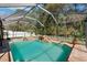 The pool features a rock waterfall and a tranquil, screened-in backyard at 4821 Barchetta Dr, Land O Lakes, FL 34639