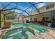 This beautiful pool features a rock waterfall, a spa and adjoins the covered patio at 4821 Barchetta Dr, Land O Lakes, FL 34639