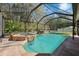 Beautiful screened-in pool and spa area with a lush, landscaped backdrop at 4821 Barchetta Dr, Land O Lakes, FL 34639