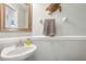 Stylish powder room with vessel sink, decorative mirror, and neutral tones, creating a welcoming space at 4821 Barchetta Dr, Land O Lakes, FL 34639