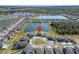 Panoramic aerial shot of a community, showcasing a house backing onto a lake with community landscaping at 4904 Eagle Rock Dr, Wimauma, FL 33598