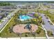 Aerial view highlighting a community pool and playground area, perfect for Gathering fun and recreation at 4904 Eagle Rock Dr, Wimauma, FL 33598