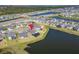 An aerial perspective captures the property's location near a lake, surrounded by community homes at 4904 Eagle Rock Dr, Wimauma, FL 33598