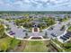 Aerial view of community clubhouse, pool, and parking area in a well-maintained residential neighborhood at 4904 Eagle Rock Dr, Wimauma, FL 33598