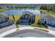 Aerial view of a lovely home with a spacious yard and a serene lake backdrop in a residential area at 4904 Eagle Rock Dr, Wimauma, FL 33598