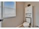 Cozy half bathroom with a toilet, built in shelving and a window at 4904 Eagle Rock Dr, Wimauma, FL 33598