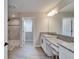 Bathroom features double vanities, granite countertops, and a glass-enclosed shower at 4904 Eagle Rock Dr, Wimauma, FL 33598