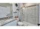 Well-lit bathroom with granite countertop, decorative wreath, modern fixtures, and seamless glass shower at 4904 Eagle Rock Dr, Wimauma, FL 33598
