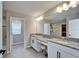 Bathroom features double vanities, granite countertops, and is conveniently connected to an adjacent closet at 4904 Eagle Rock Dr, Wimauma, FL 33598