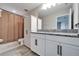 Bathroom featuring a double sink vanity with granite countertop, tiled floors and a linen closet at 4904 Eagle Rock Dr, Wimauma, FL 33598