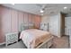 Bedroom features a stylish pink accent wall, neutral paint, and plenty of natural light at 4904 Eagle Rock Dr, Wimauma, FL 33598