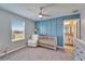 Cozy bedroom with a crib, chair and a calming blue accent wall at 4904 Eagle Rock Dr, Wimauma, FL 33598