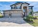 A charming home with a three-car garage and stone detailing, complemented by a paved driveway at 4904 Eagle Rock Dr, Wimauma, FL 33598