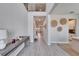 Bright foyer features light gray wood-look tile, hall table, decorative wall art, and an open view to the second floor at 4904 Eagle Rock Dr, Wimauma, FL 33598
