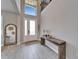 Bright foyer with high ceilings, tiled floor, modern console table, and a decorative mirror at 4904 Eagle Rock Dr, Wimauma, FL 33598