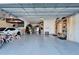 Spacious garage featuring epoxy flooring, organized storage shelves, and ample room for parking and storage at 4904 Eagle Rock Dr, Wimauma, FL 33598