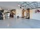 Bright garage featuring durable epoxy flooring, organized storage solutions, and plenty of parking and workspace at 4904 Eagle Rock Dr, Wimauma, FL 33598