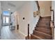 Inviting hallway with wood stairs, front door, and easy access to the laundry room at 4904 Eagle Rock Dr, Wimauma, FL 33598