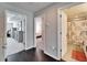 Hallway showing doorways to a bedroom and a bathroom with colorful decor at 4904 Eagle Rock Dr, Wimauma, FL 33598