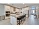 Kitchen featuring a large island with barstool seating, stainless steel appliances, and white cabinets at 4904 Eagle Rock Dr, Wimauma, FL 33598
