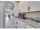 Kitchen featuring white cabinets, stainless steel appliances, granite countertops, and a breakfast bar at 4904 Eagle Rock Dr, Wimauma, FL 33598