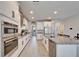 Bright kitchen featuring white cabinets, stainless steel appliances, granite countertops, and an island with seating at 4904 Eagle Rock Dr, Wimauma, FL 33598