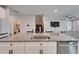 Granite kitchen island featuring stainless steel appliances, white cabinets, seating, and an open floor plan at 4904 Eagle Rock Dr, Wimauma, FL 33598