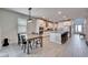 Open-concept kitchen with a dining table, an island with barstool seating, stainless steel appliances, and white cabinets at 4904 Eagle Rock Dr, Wimauma, FL 33598