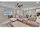 Spacious living room featuring a large sectional sofa, neutral tones, and ample natural light at 4904 Eagle Rock Dr, Wimauma, FL 33598