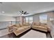 Bright living room with neutral colored couches, dark wood floors, and a ceiling fan at 4904 Eagle Rock Dr, Wimauma, FL 33598