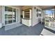 Charming covered patio with stylish outdoor cabinet, sliding door entrance, and view of the serene backyard at 4904 Eagle Rock Dr, Wimauma, FL 33598
