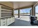 Covered patio features an outdoor bar cabinet and screened-in enclosure with picturesque water views at 4904 Eagle Rock Dr, Wimauma, FL 33598