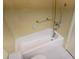 Close-up of the bathroom bathtub with safety bars and shower head for added accessibility and convenience at 5095 Bay Ne St # 310, St Petersburg, FL 33703