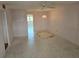 Empty living room featuring vintage chandelier and ceiling fan ready for decorating and new flooring at 5095 Bay Ne St # 310, St Petersburg, FL 33703