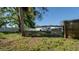 Backyard view with a tree and a partial view of the home at 5712 Mallow St, New Port Richey, FL 34652