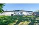 View of the backyard with grass and the house in the background at 5712 Mallow St, New Port Richey, FL 34652