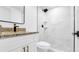 Sleek bathroom featuring a white vanity, granite countertop, and tiled shower with rain showerhead at 5712 Mallow St, New Port Richey, FL 34652
