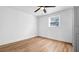 Bright bedroom with wood floors, ceiling fan, and large window at 5712 Mallow St, New Port Richey, FL 34652