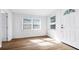 Bright entryway with natural light, wood-look floors, and a freshly painted white door at 5712 Mallow St, New Port Richey, FL 34652